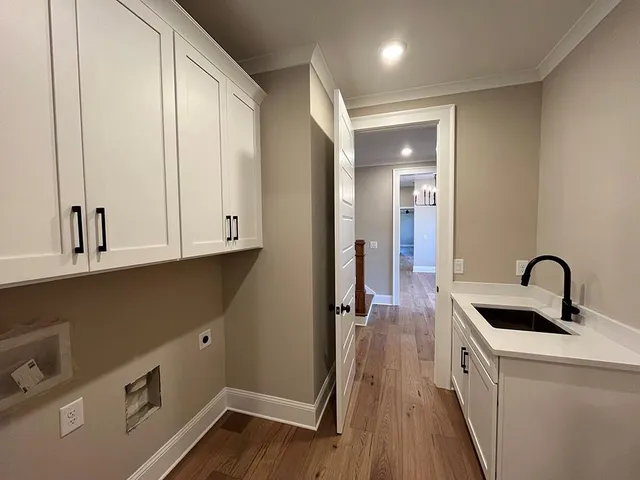 a kitchen with a sink a refrigerator and cabinets