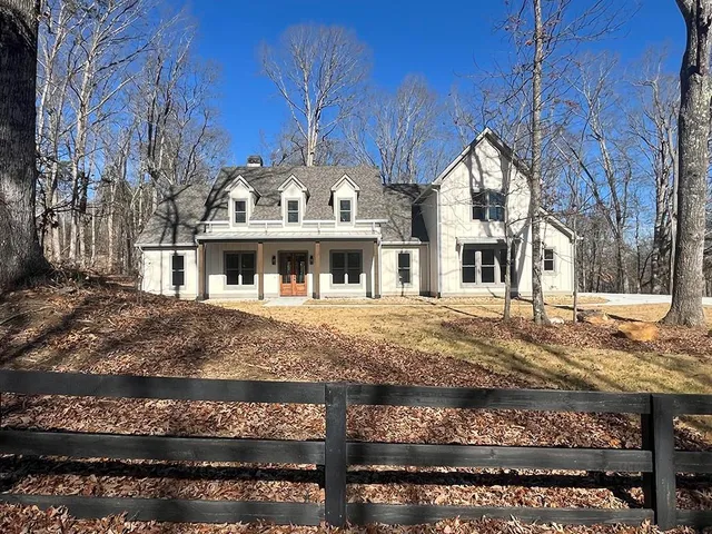 a view of a large house with large trees