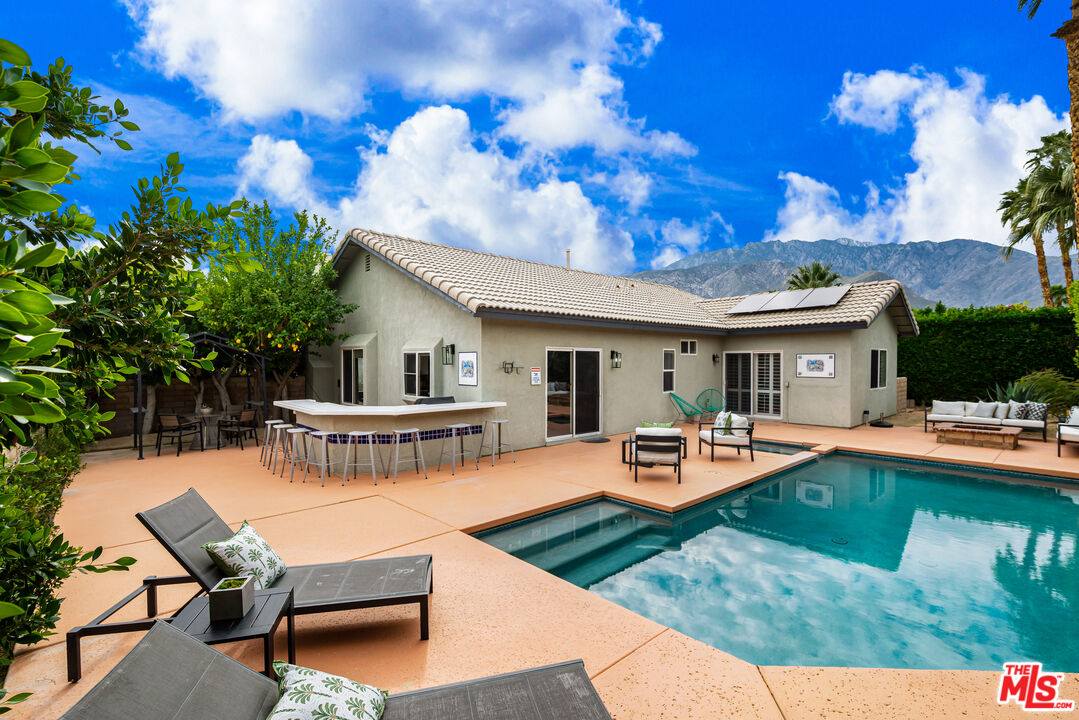 1602 Olga Way Palm Springs, CA 92262 - Photo 13 of 13 a view of a house with swimming pool and sitting area