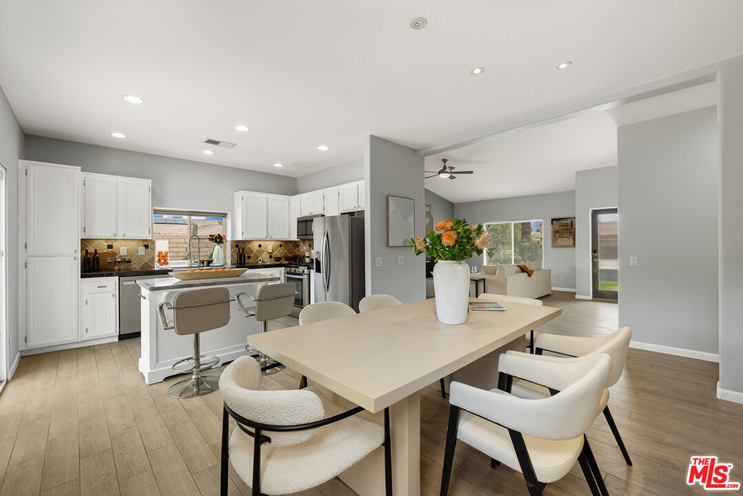 1602 Olga Way Palm Springs, CA 92262 - Photo 4 of 13 a kitchen with refrigerator and cabinets