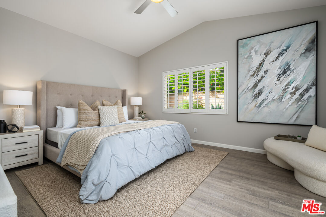 1602 Olga Way Palm Springs, CA 92262 - Photo 6 of 13 a spacious bedroom with a bed and a couch