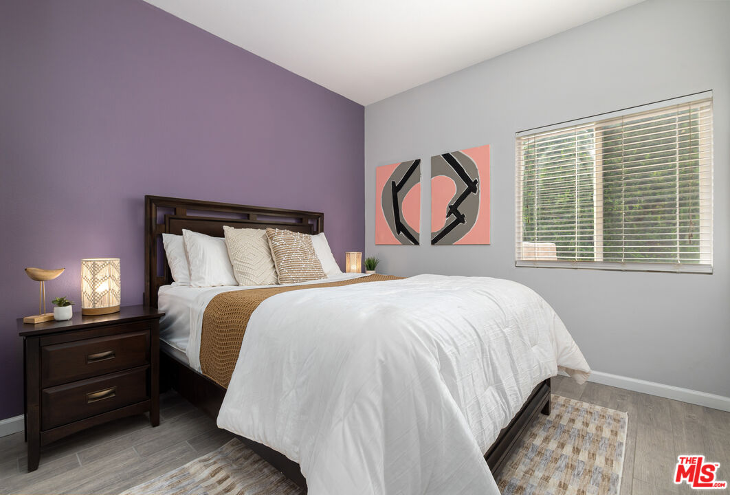 1602 Olga Way Palm Springs, CA 92262 - Photo 9 of 13 a bedroom with a bed and a lamp next to a window