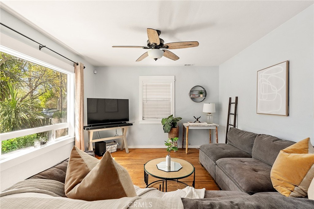 1151 Normal Avenue Chico, CA 95928 - Photo 2 of 32 a living room with furniture a large window and a flat screen tv