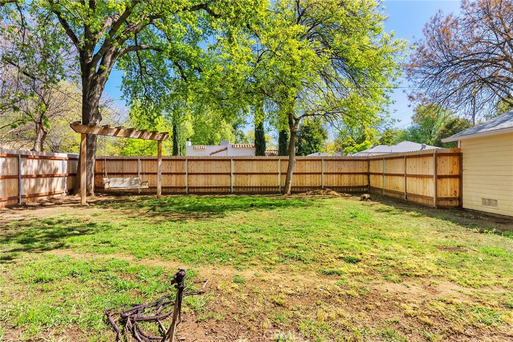 1151 Normal Avenue Chico, CA 95928 - Photo 26 of 32 a view of backyard with wooden fence and trees