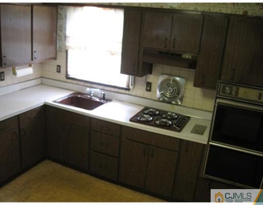 21 Daniel Road Spotswood, NJ 08884 - Photo 4 of 12 a kitchen with a sink stove and cabinets