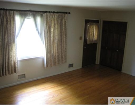 21 Daniel Road Spotswood, NJ 08884 - Photo 6 of 12 an empty room with windows