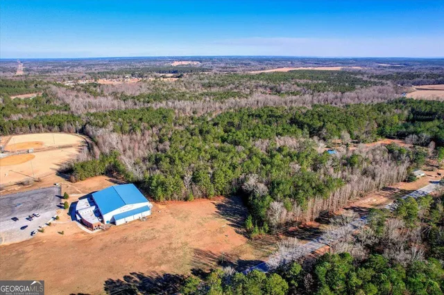 an aerial view of a house with a yard