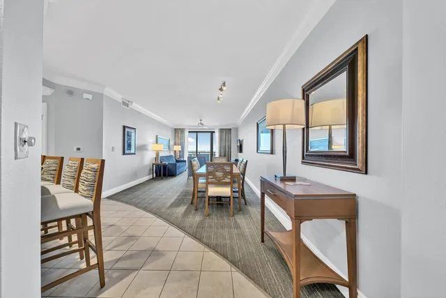 a living room with furniture a dining table and a window