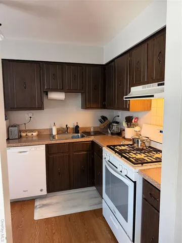 a kitchen with stainless steel appliances a stove a sink and a refrigerator