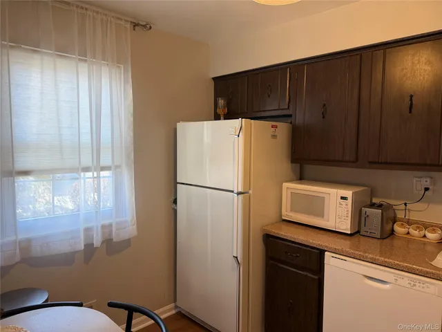a white refrigerator freezer sitting in a kitchen