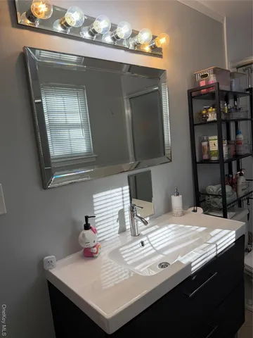 a kitchen with a sink a cabinets and wooden floor