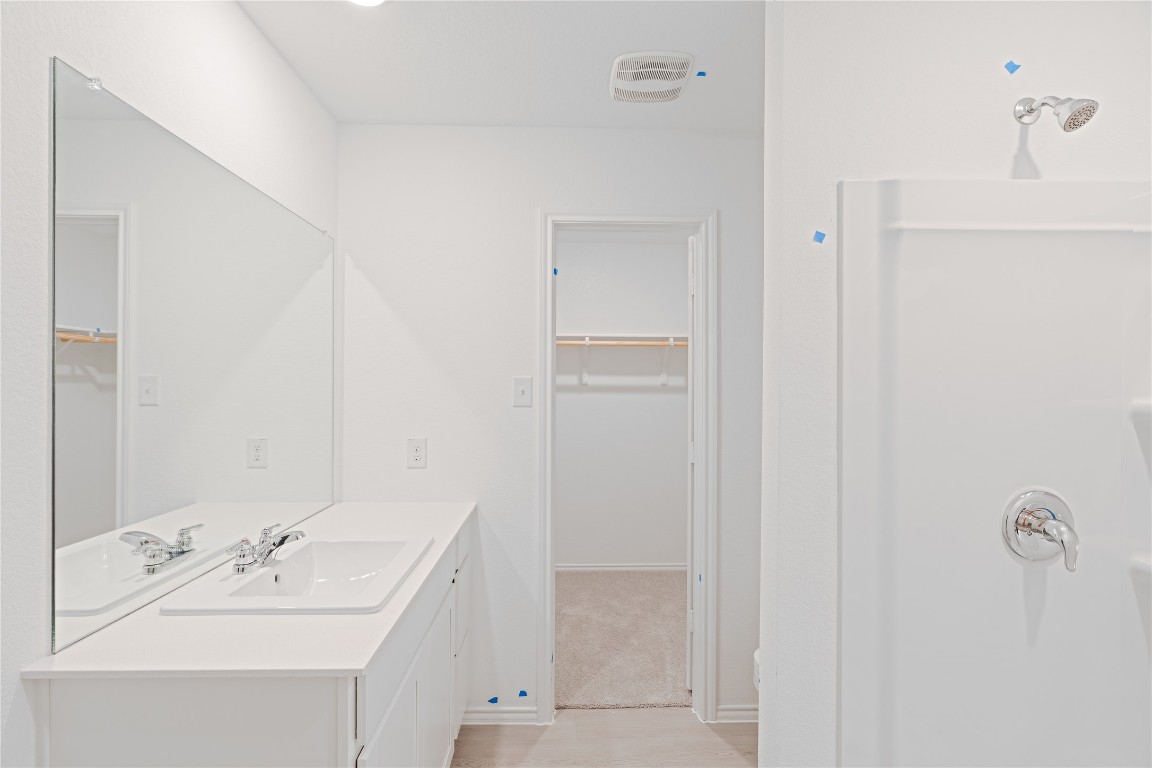 241 Kings Row Lane Jarrell, TX 76537 - Photo 14 of 27 a bathroom with a sink and a mirror