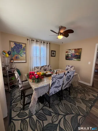 a room with a table chairs and a workspace