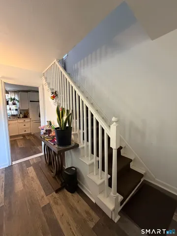 a view of entryway livingroom and hall with wooden floor