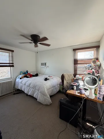a bedroom with bed and a window