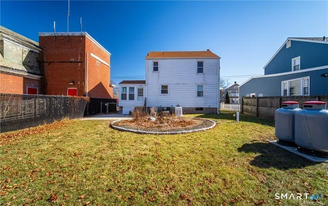 a view of a house with backyard and sitting area