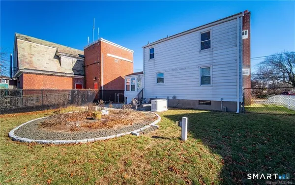 a backyard of a house with table and chairs
