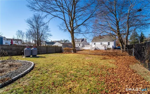 a tall yellow building with trees in the background