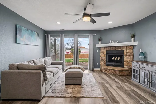 a living room with furniture a window and a fireplace