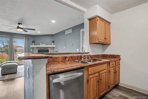 a kitchen with stainless steel appliances granite countertop a sink stove and cabinets