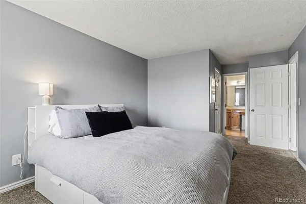 a bedroom with a bed and a lamp