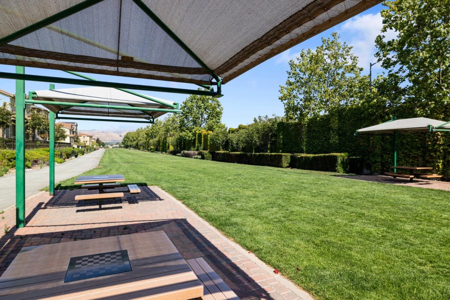 760 Mente Linda Loop Milpitas, CA 95035 - Photo 23 of 24 a view of a backyard with table and chairs under an umbrella