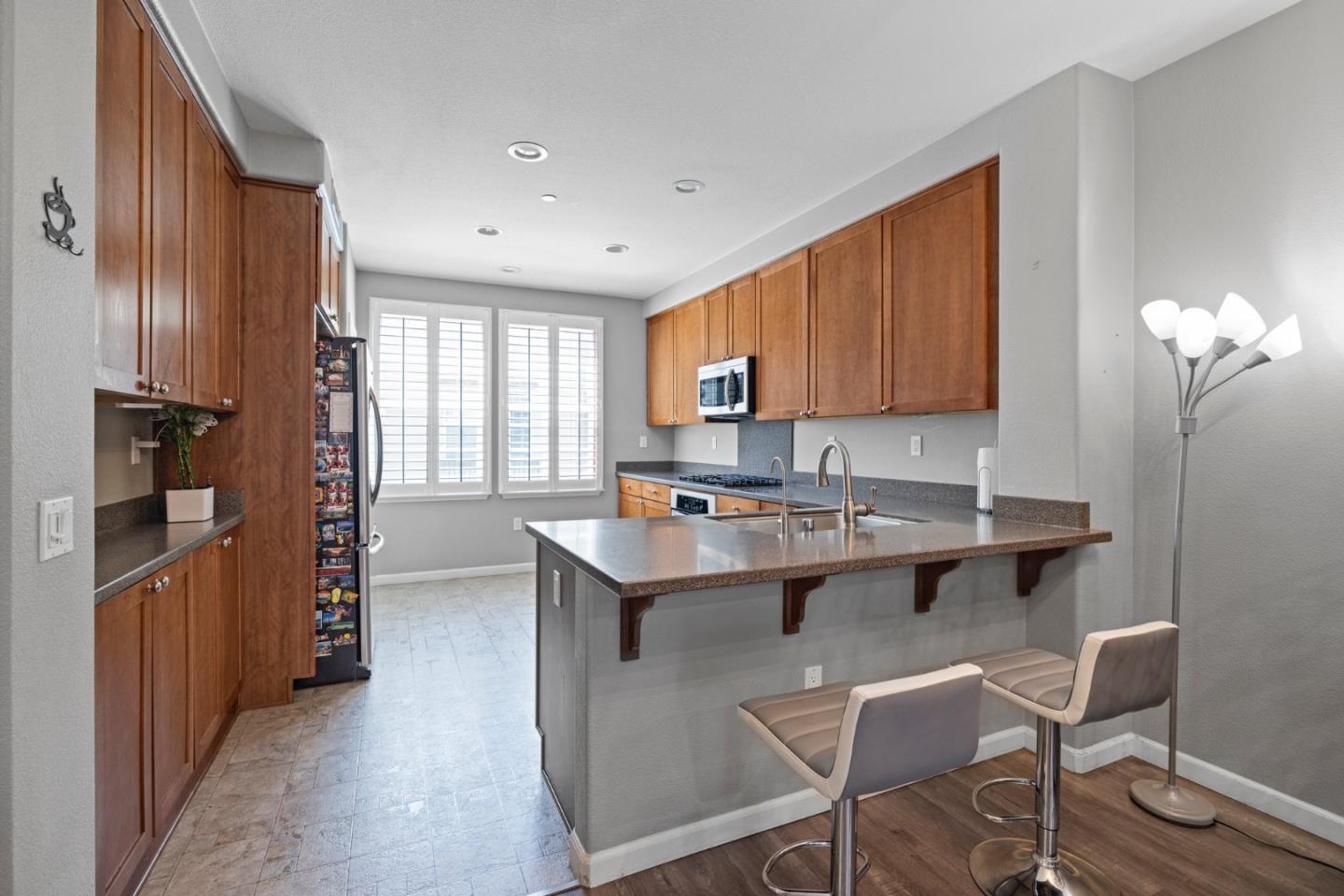 760 Mente Linda Loop Milpitas, CA 95035 - Photo 10 of 24 a kitchen with kitchen island stainless steel appliances a sink and a refrigerator