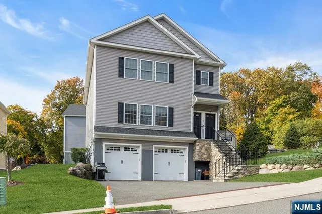 a view of house with outdoor space and parking