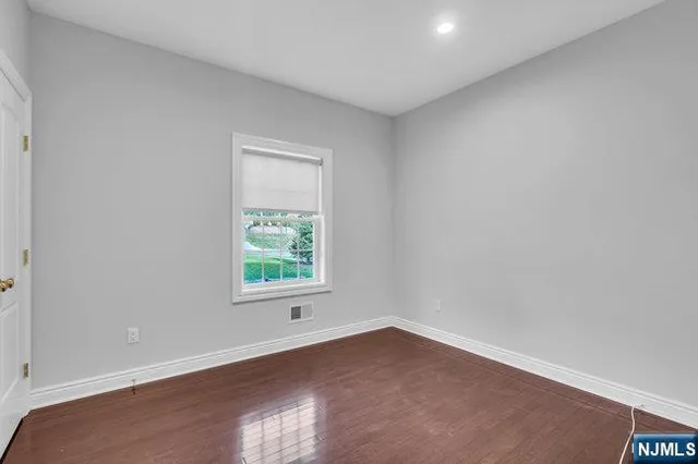 a bathroom with a granite countertop sink toilet and a mirror