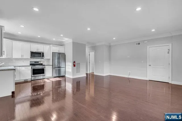 a bathroom with a granite countertop sink a toilet and a shower