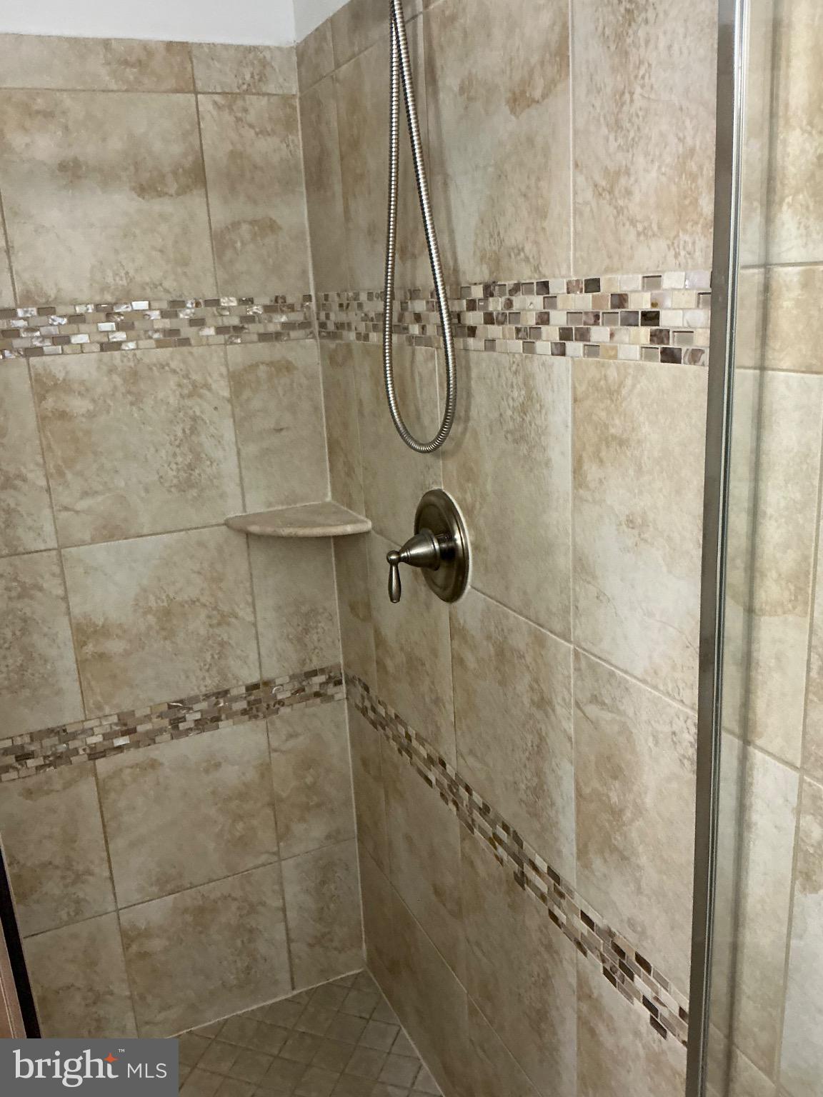 16125 Redland Road Derwood, MD 20855 - Photo 26 of 44 Modern shower with elegant tile accents.