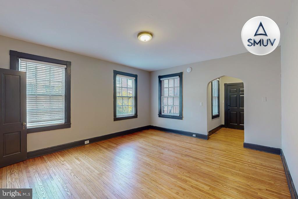 24 East Madison Street, Unit EF Baltimore, MD 21202 - Photo 7 of 23 an empty room with wooden floor and windows