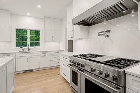 a kitchen with granite countertop a stove and a sink