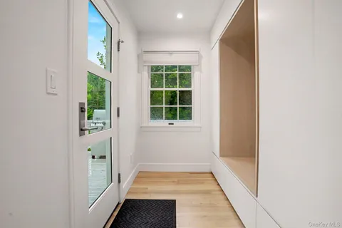 a view of an entryway with wooden floor and door