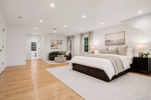 a spacious bedroom with a large bed and a large window