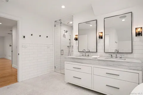 a bathroom with a granite countertop sink mirror and double
