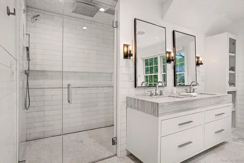 a bathroom with a shower sink and mirror