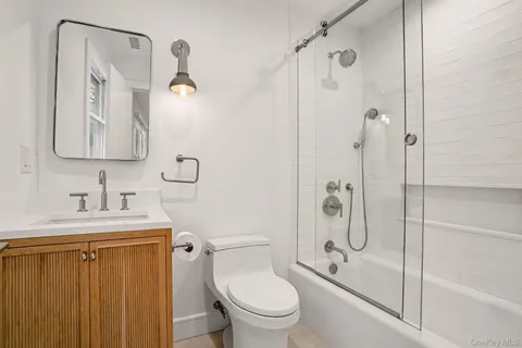 a bathroom with a granite countertop toilet sink and shower
