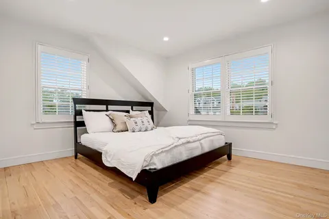 a large bed sitting in a bedroom next to a window