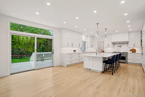 a kitchen with a table chairs microwave and cabinets