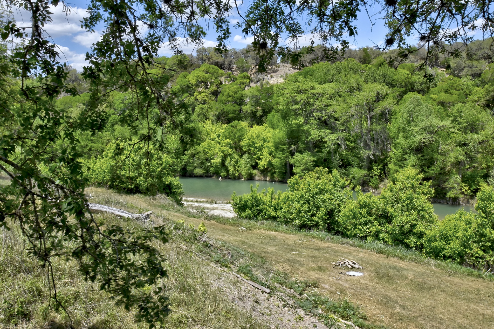 1170 Misty Lane Spring Branch, TX 78070 - Photo 18 of 24 A tranquil river winds through a verdant landscape, showcasing natural beauty.