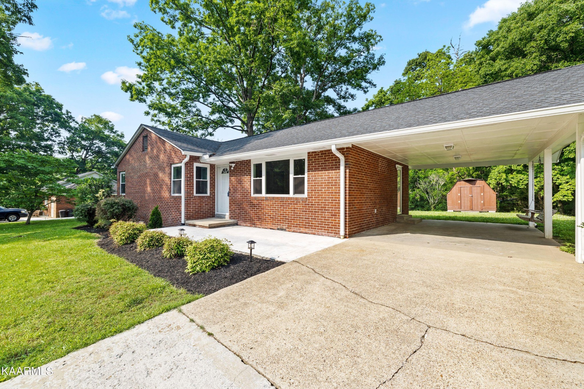 107 Forest Circle Powell, TN 37849 - Photo 14 of 14 a front view of a house with a yard and potted plants