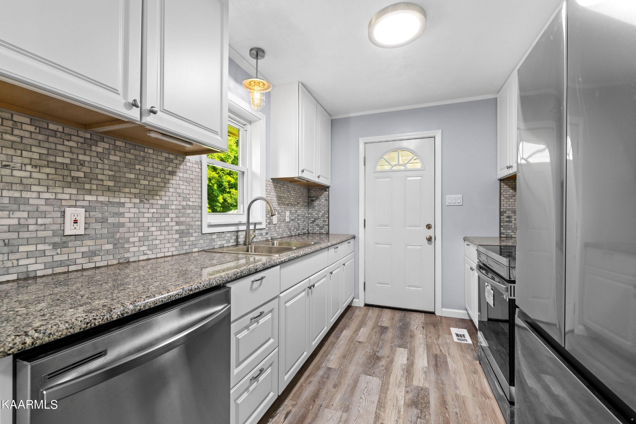 107 Forest Circle Powell, TN 37849 - Photo 4 of 14 a kitchen with a sink and refrigerator