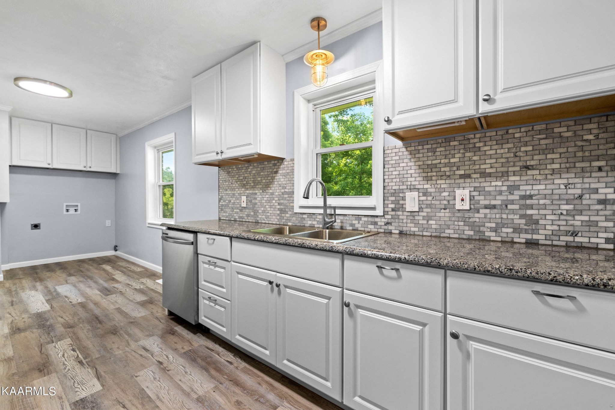 107 Forest Circle Powell, TN 37849 - Photo 5 of 14 a kitchen with granite countertop a sink stainless steel appliances white cabinets and a window