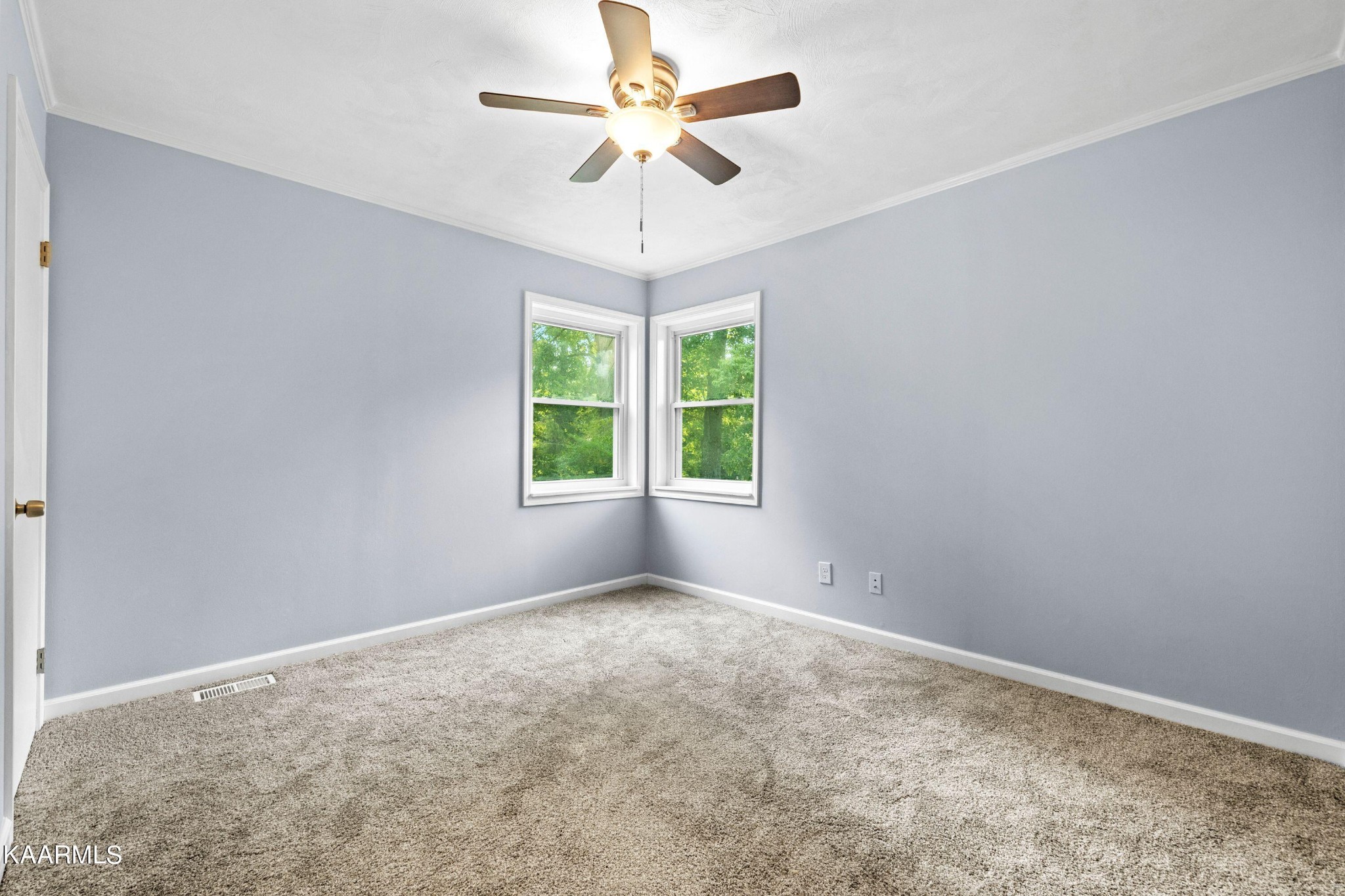 107 Forest Circle Powell, TN 37849 - Photo 8 of 14 an empty room with a chandelier fan and windows