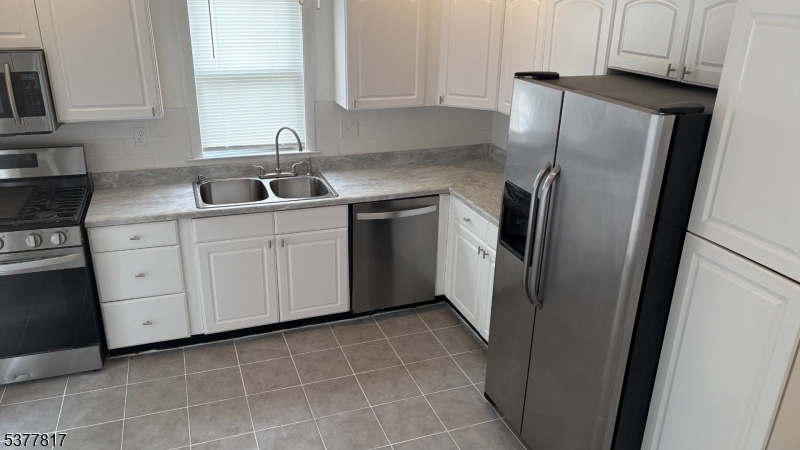1776 North Tuckahoe Road Williamstown, NJ 08094 - Photo 7 of 16 a kitchen with a refrigerator sink and cabinets