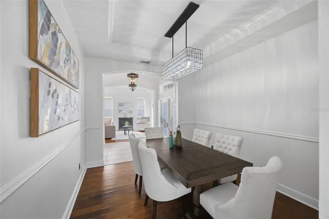 a living room with furniture fireplace and a chandelier