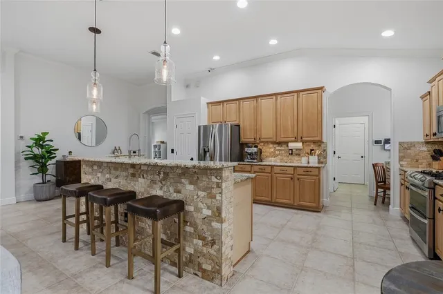 a kitchen with stainless steel appliances granite countertop a stove sink and cabinets