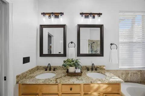 a bathroom with a sink a mirror and a window