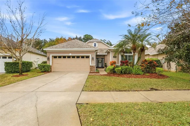 a front view of a house with a yard and garage